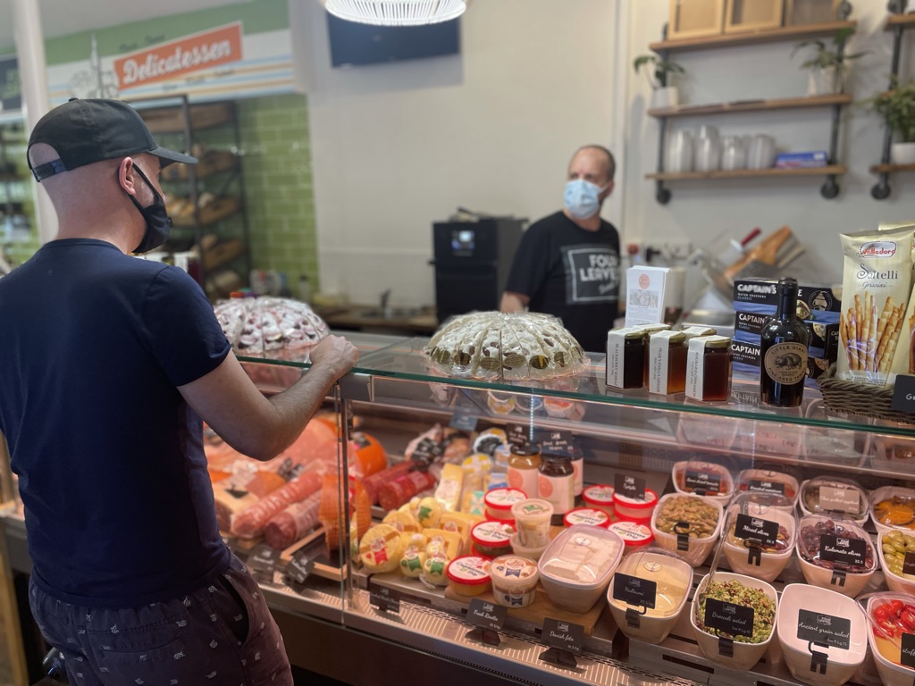 Four Leaves Food Store Deli Bakery owner and chef, Rodney Van Oirschot, serves at the deli counter where there is a wide variety of quality cheeses, cured meats, salads and pickled vegetables - all necessary essential ingredients to make the best Reuben sandwich
